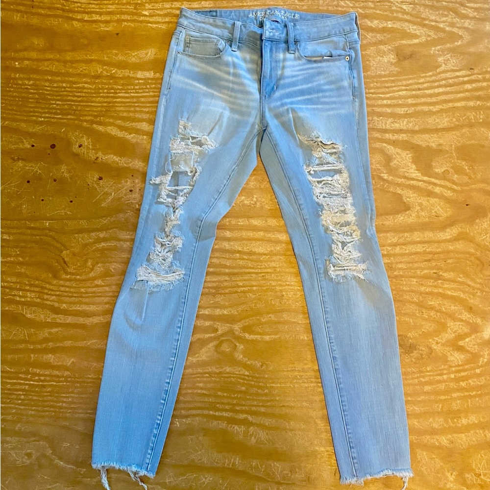 Light blue American eagle size 8 straight jeans with holes down legs